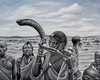 Handmade African painting in grayscale showing a man blowing a horn with tribal figures, contemporary art for sale.