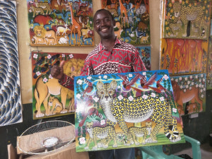 our african artist holding a painting